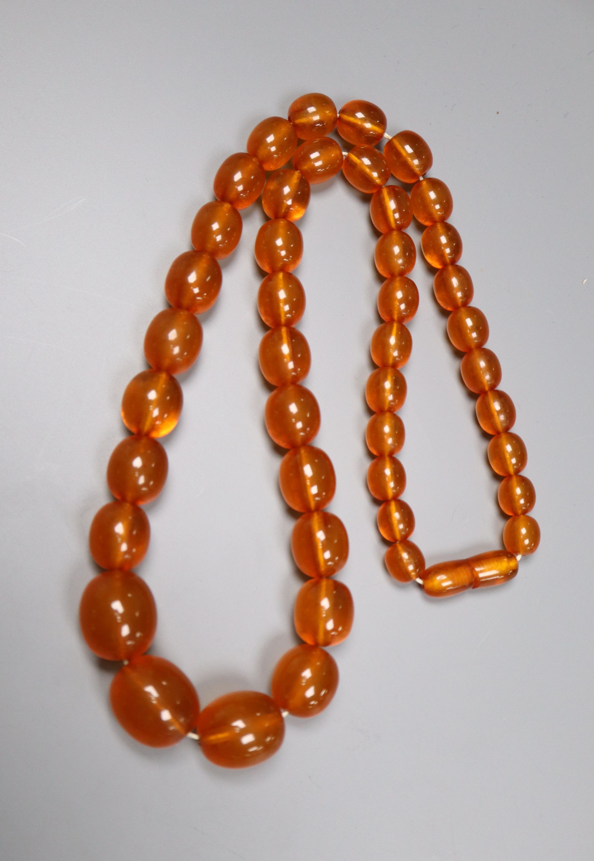 A single strand graduated oval amber bead necklace, 52cm, gross 42 grams.